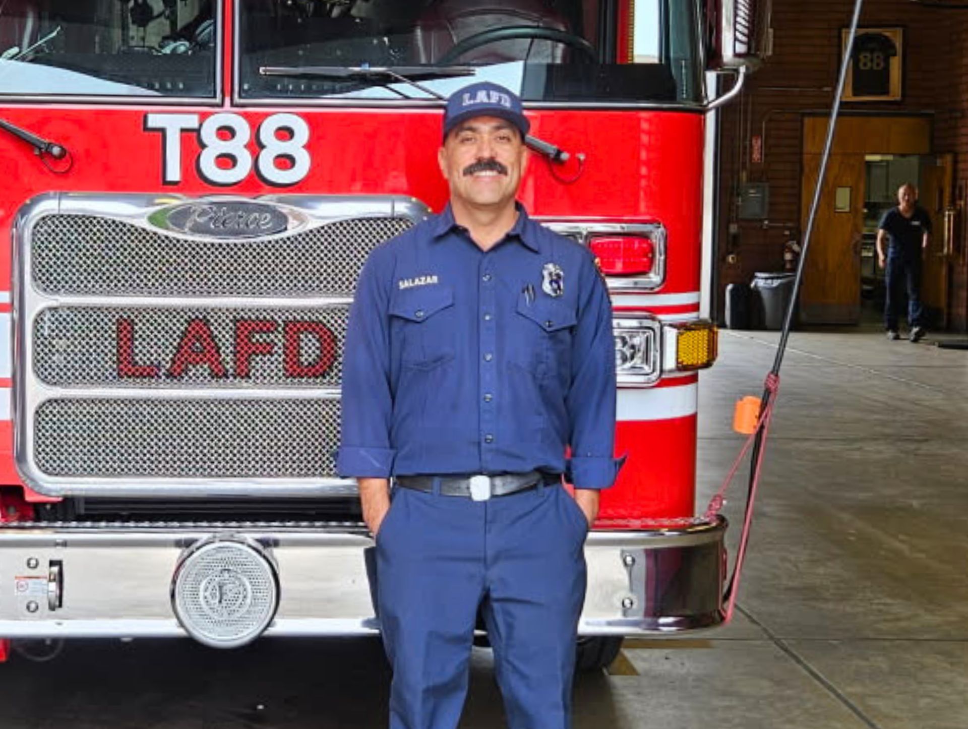 Engineer Brandon Colburn standing in front of an LAFD engine.