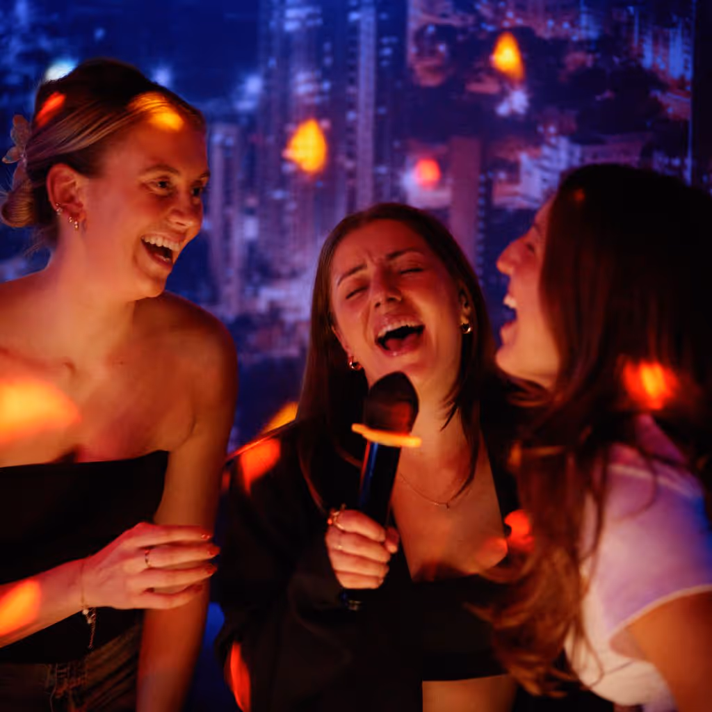 Group of girls singing karaoke having fun