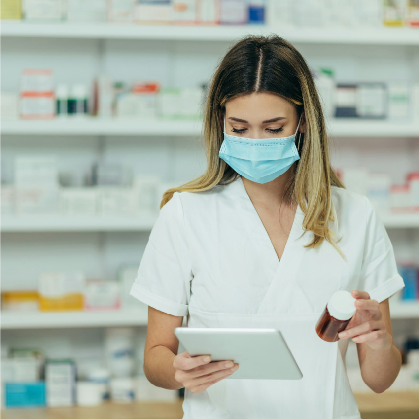 A female pharmacy employee using a tablet