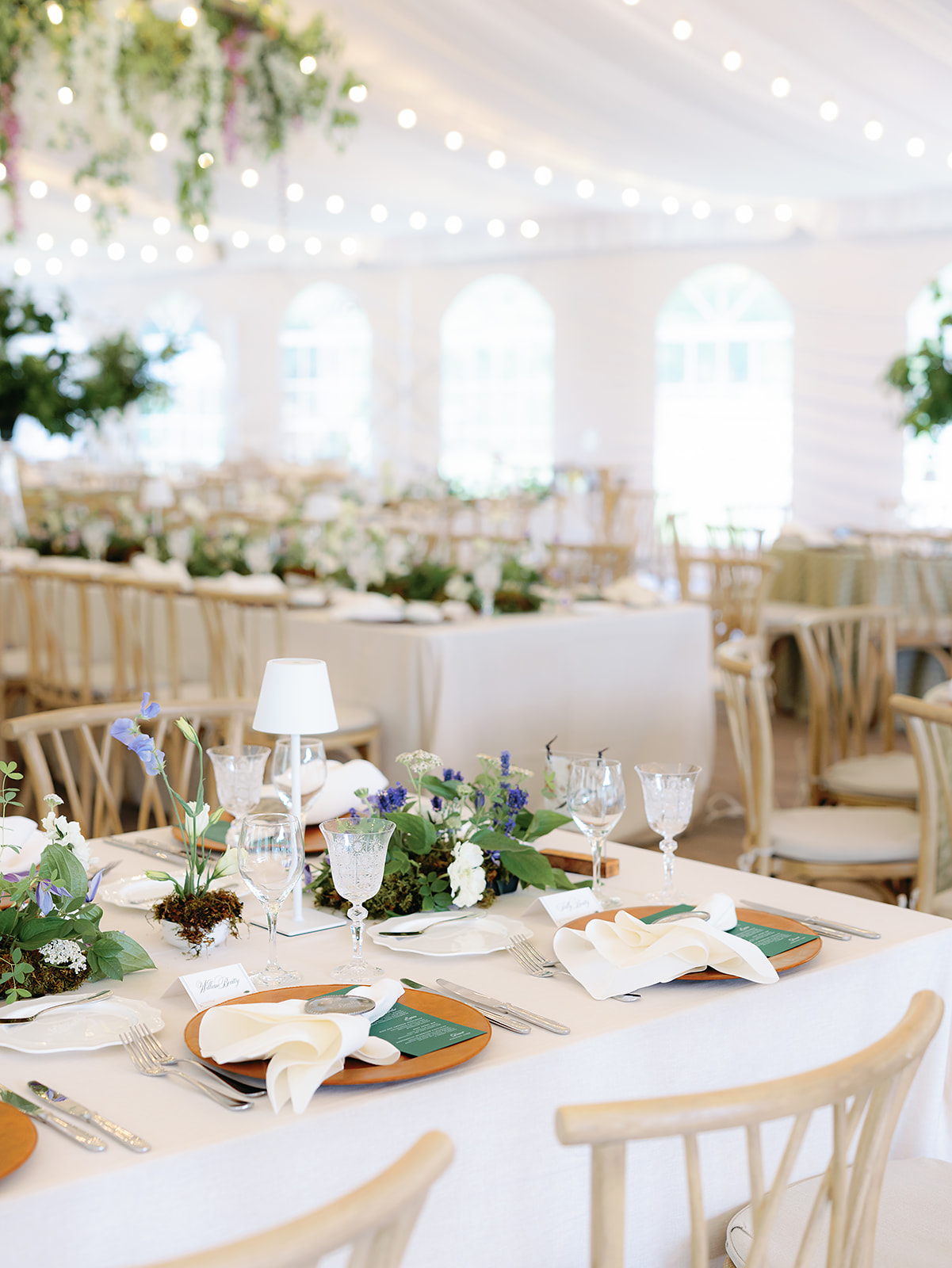 Wide view of garden-inspired reception tables with mossy florals and soft greenery at a Trail Creek Cabin wedding in Sun Valley.