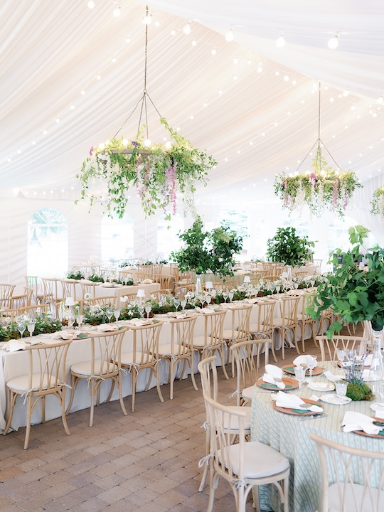 Reception tent at trail creek cabin with hanging floral chandeliers