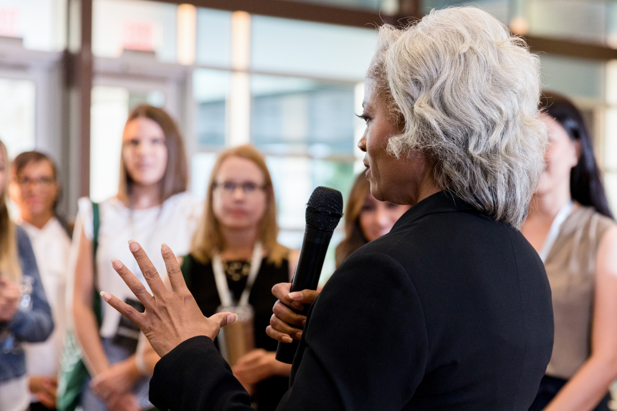 woman presenting to group | We. Communications