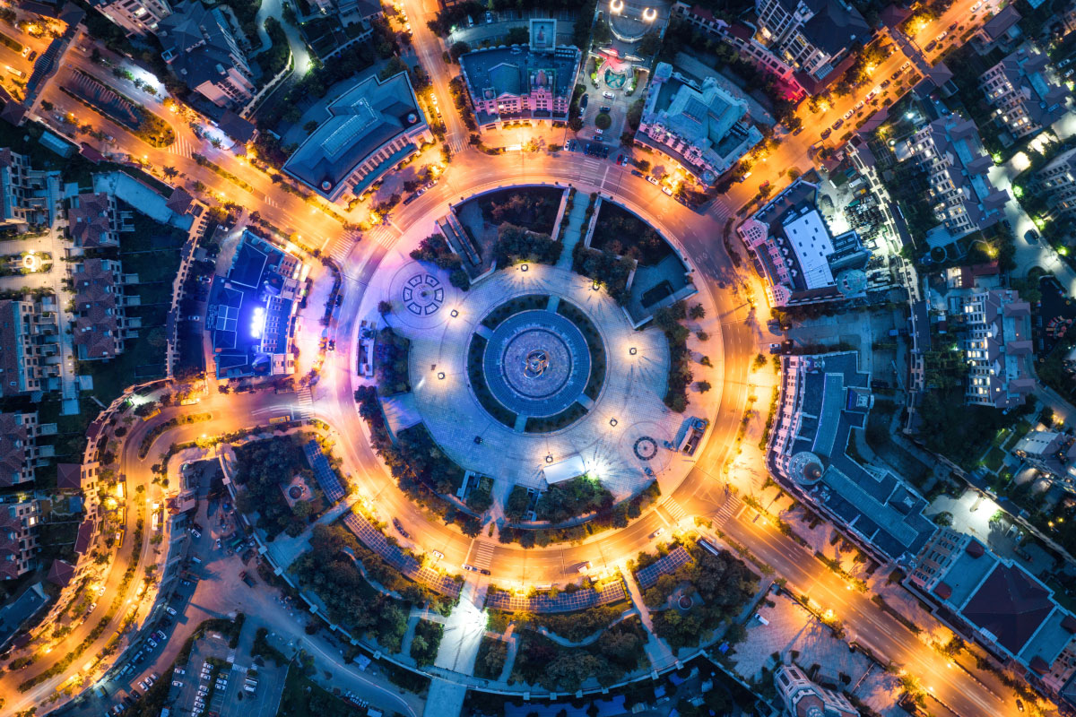 Overhead view of busy traffic circle in the evening