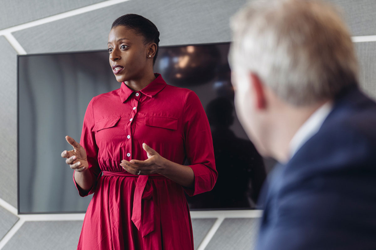 person speaking to board room