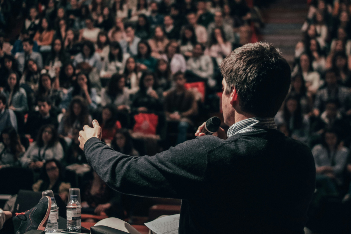 Person speaking in front of crowd