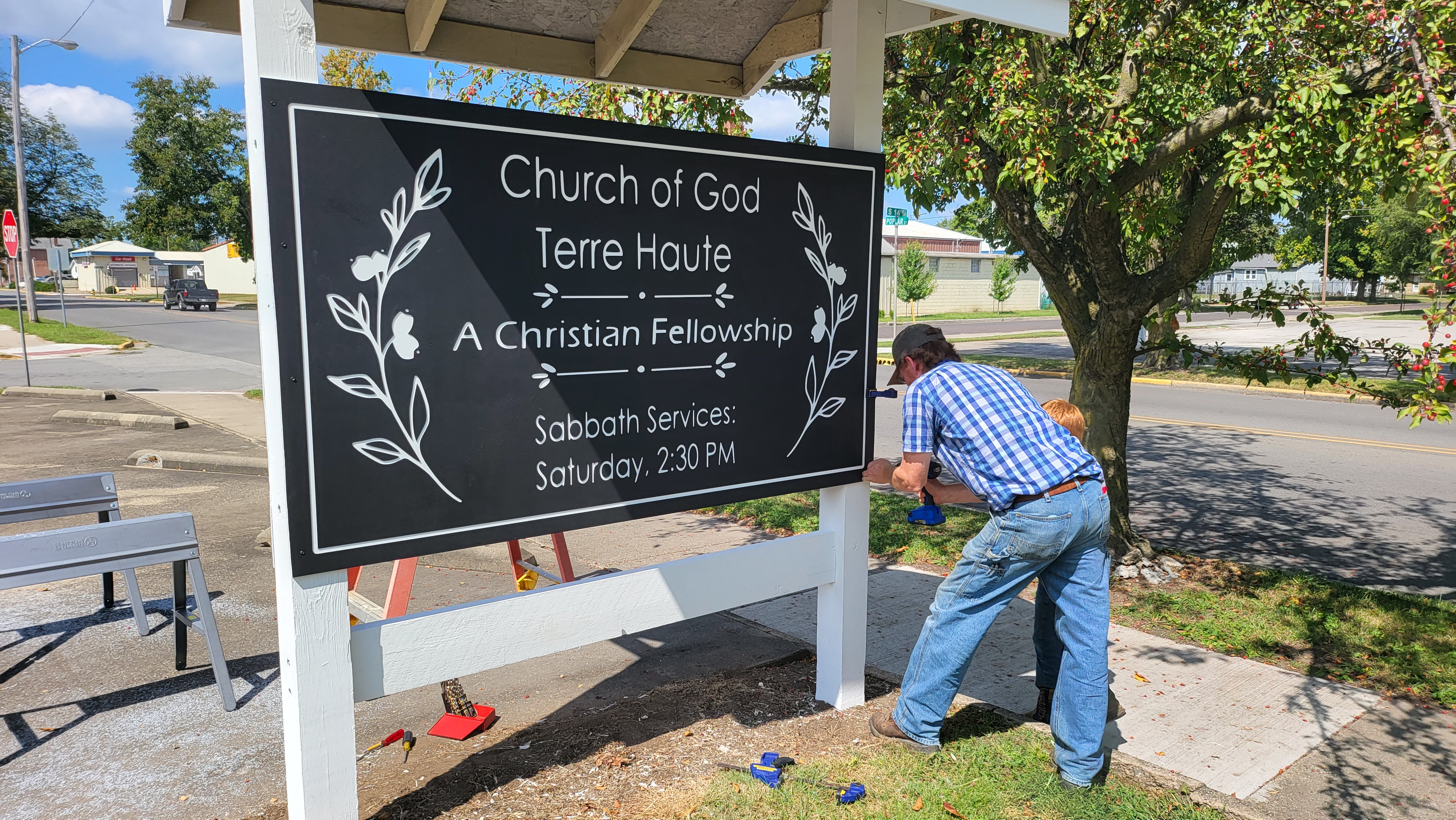 Members installing our new church sign, located at 1403 Poplar St.