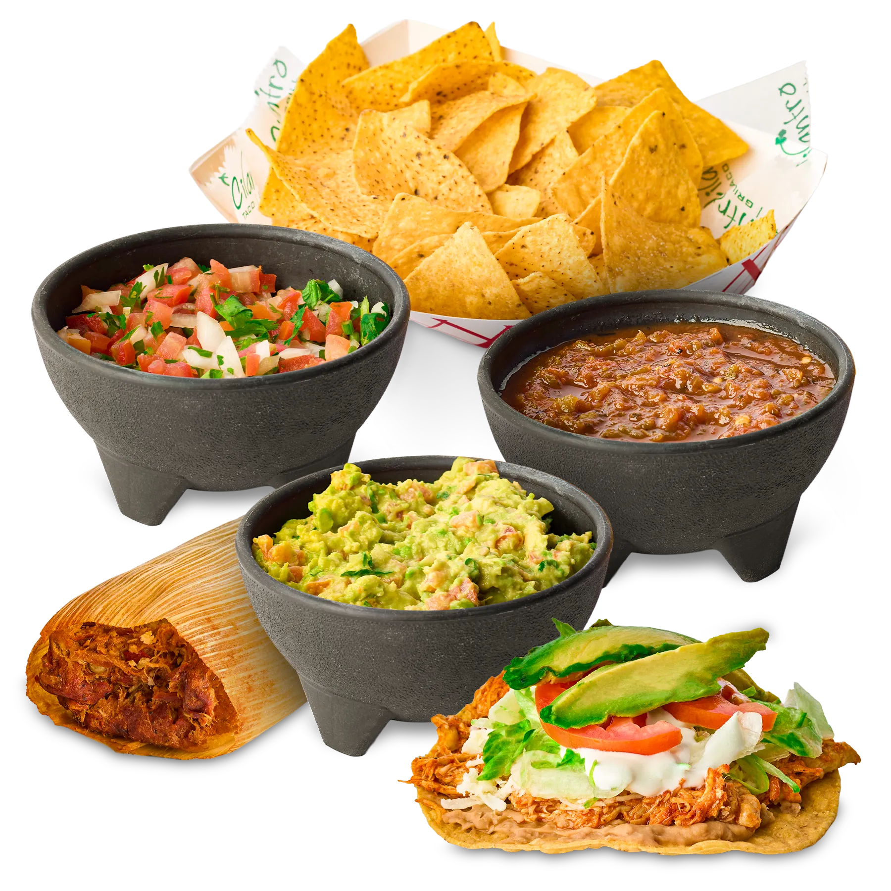 An appetizing display of traditional Mexican antojitos and sides, featuring fresh tortilla chips, guacamole, pico de gallo, and roasted salsa in stone bowls, alongside a savory pork tamal and a crispy chicken tostada topped with lettuce, tomato, and avocado.