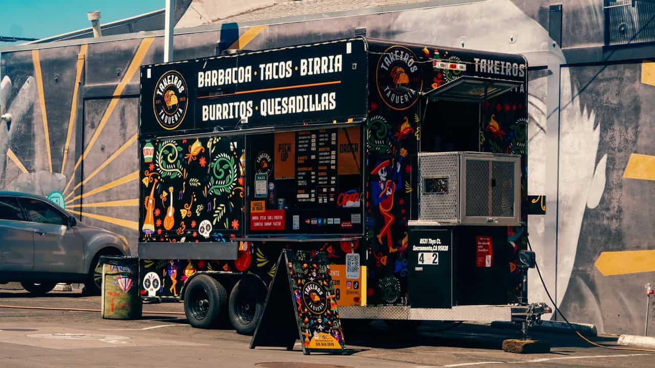 Medium black food trailer with a burritos and quesadillas menu wrap in North Carolina