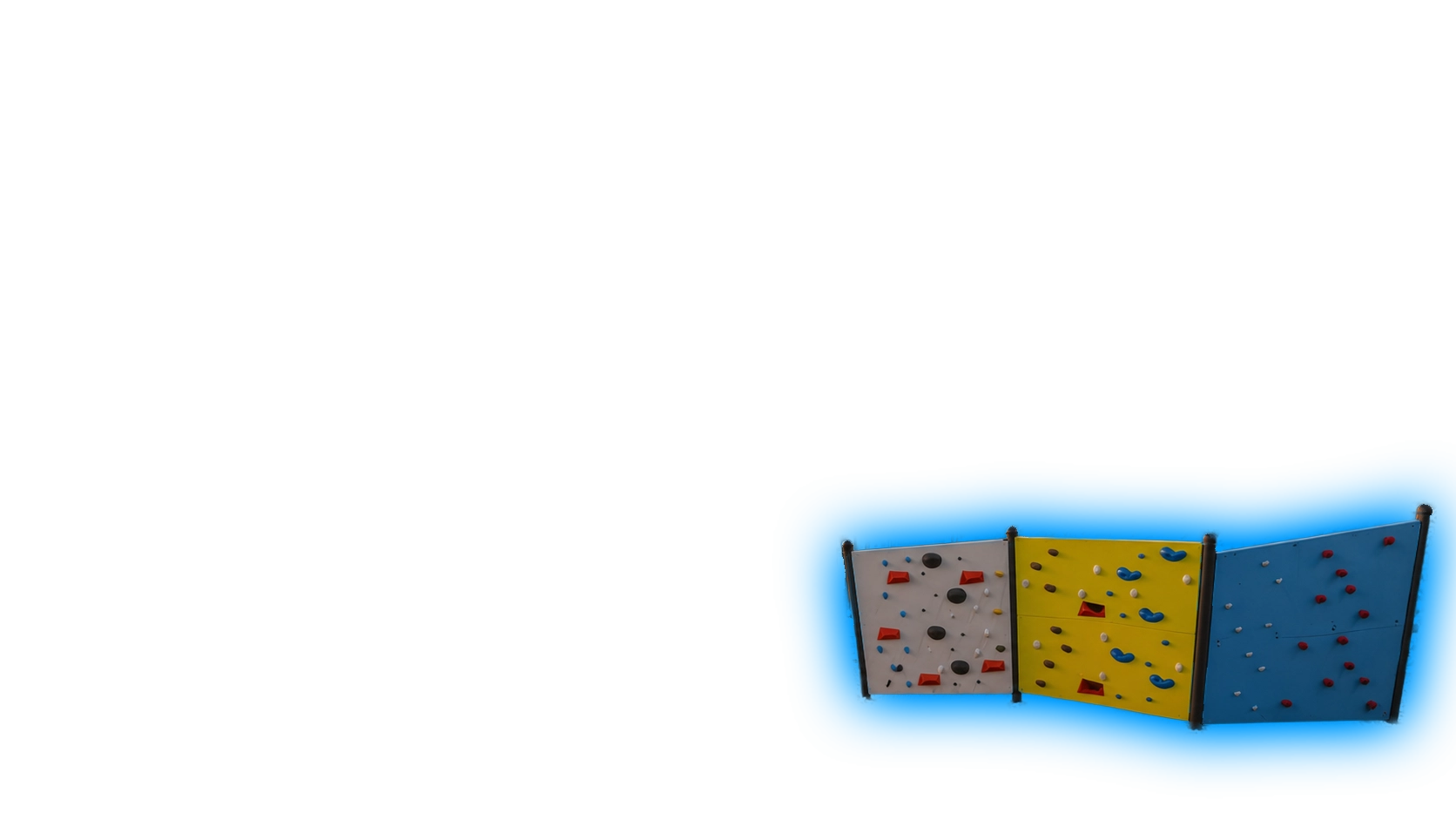 Large angular artificial climbing boulder with handholds against a blue background.