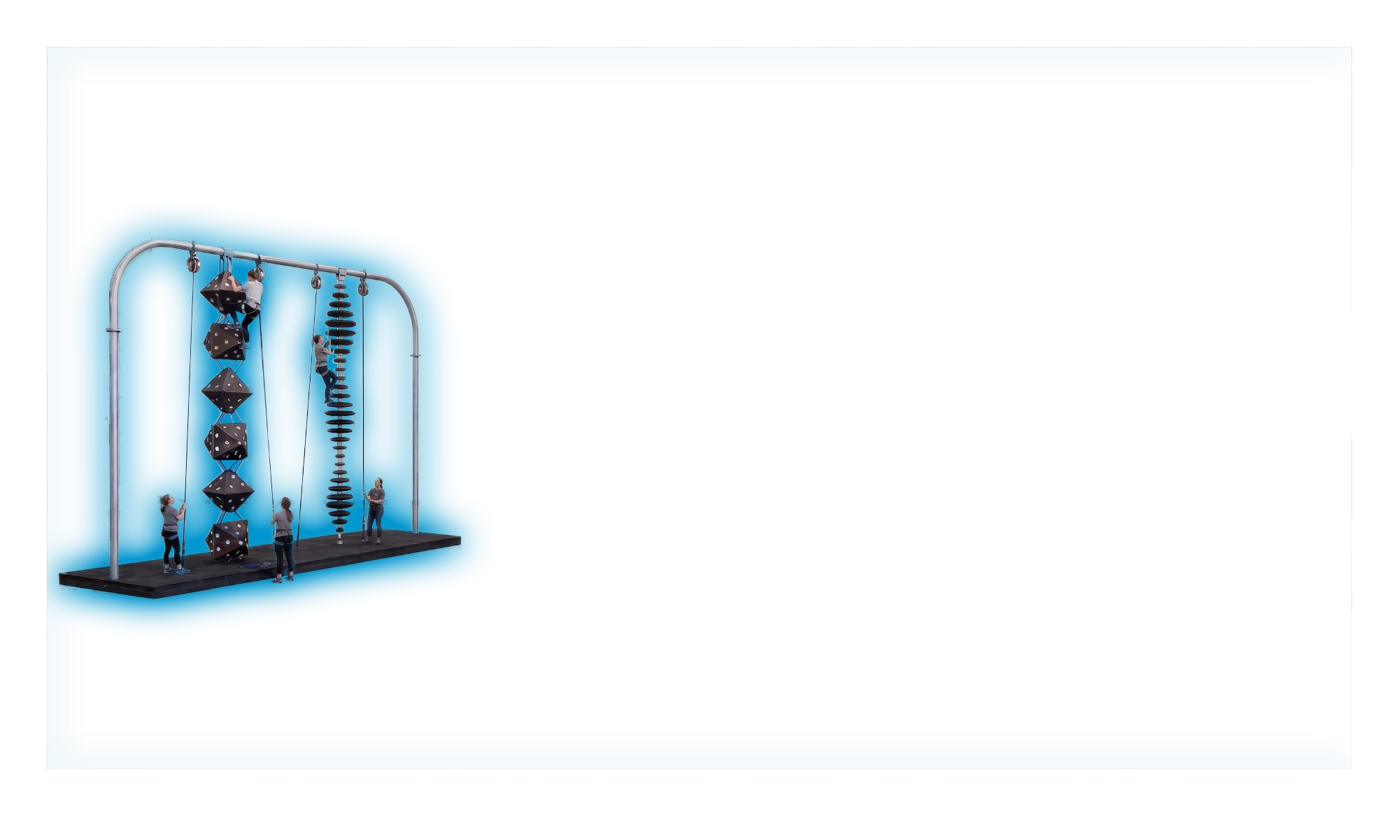 Gray angular climbing boulder with multiple bolt holes on a blue background.