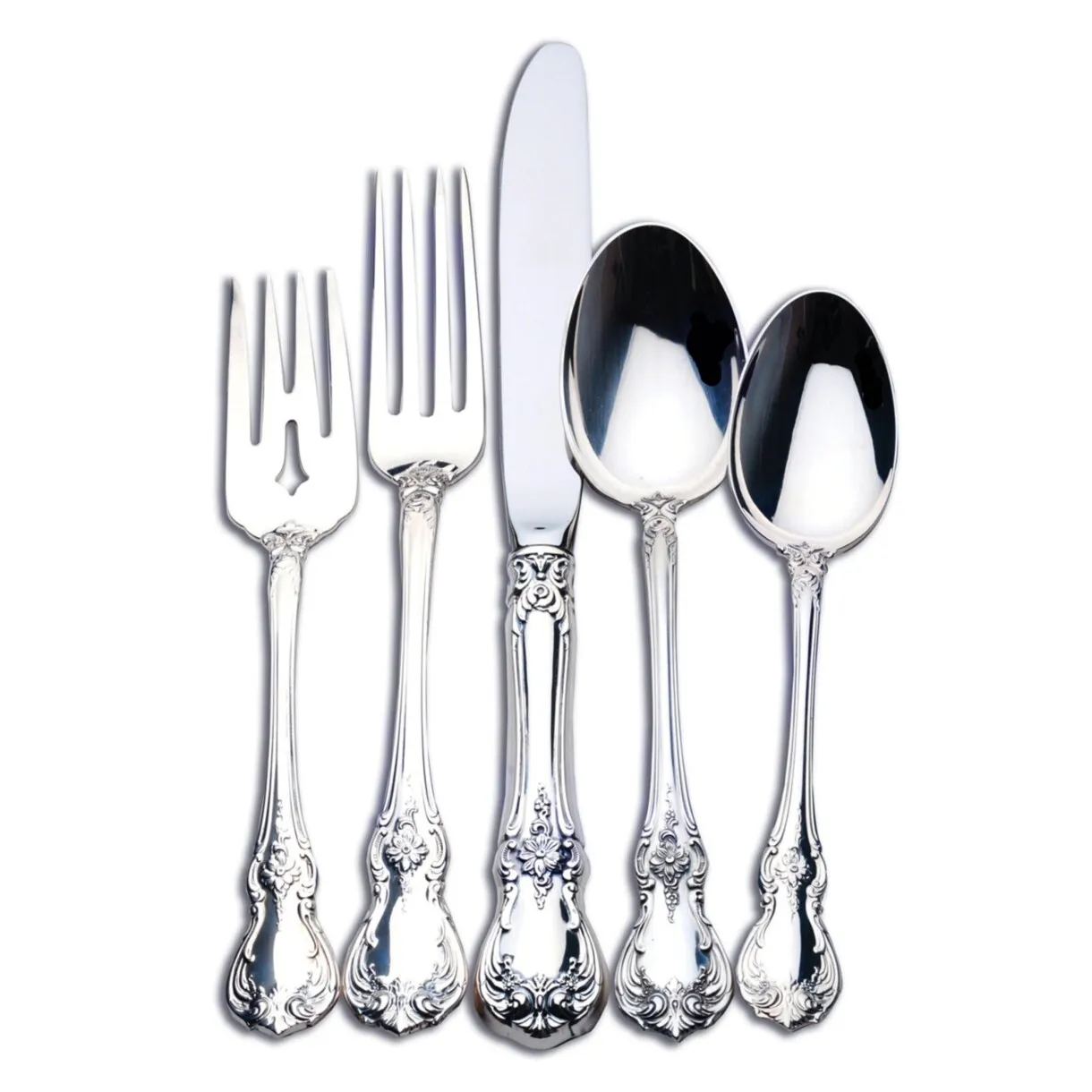 Five-piece silver flatware set with ornate floral and scroll handles including fork, knife, and spoons.