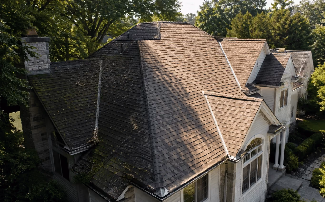 Roof with sunny and shaded sections showing different aging patterns caused by varying sun, moisture, and environmental exposure.