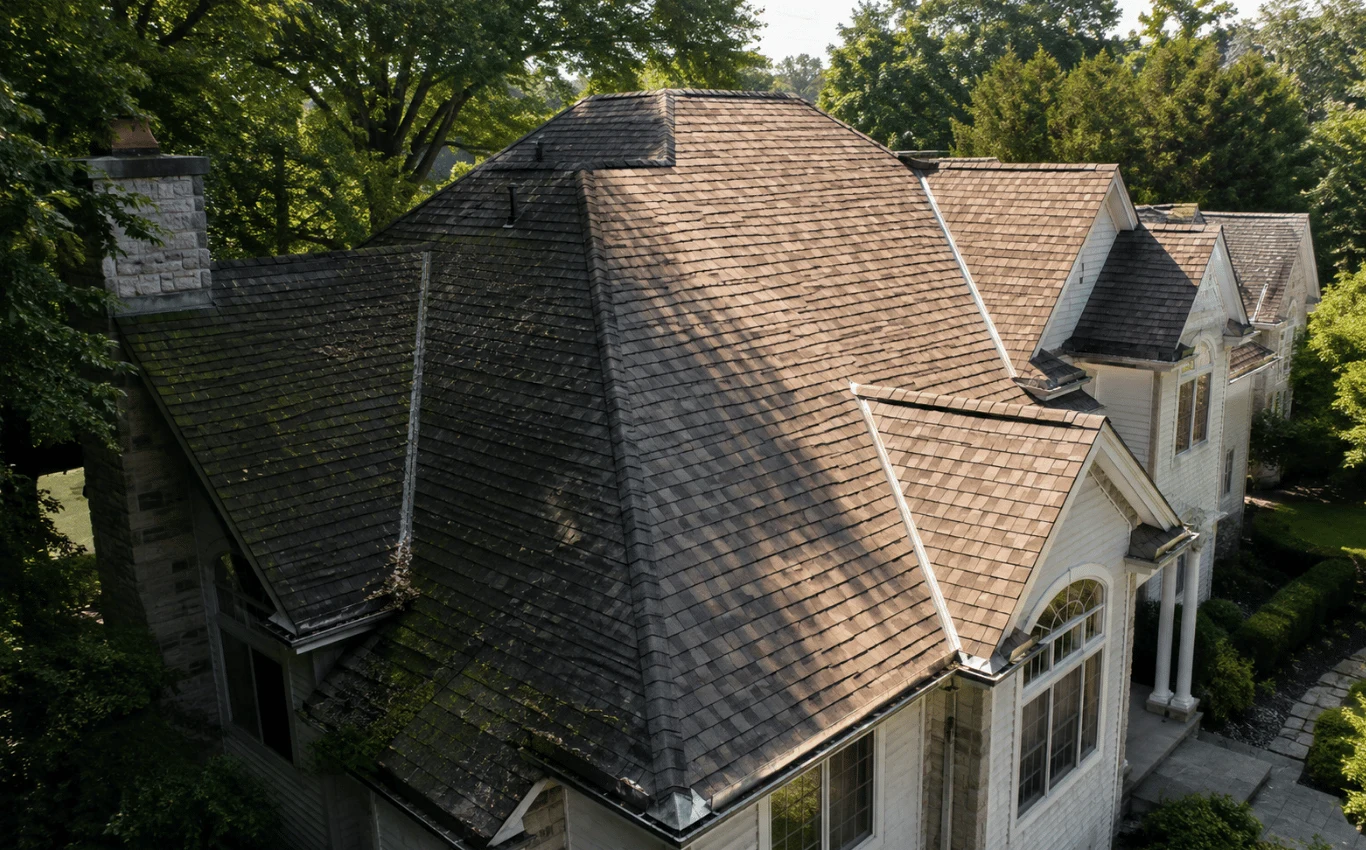 Roof with sunny and shaded sections showing different aging patterns caused by varying sun, moisture, and environmental exposure.