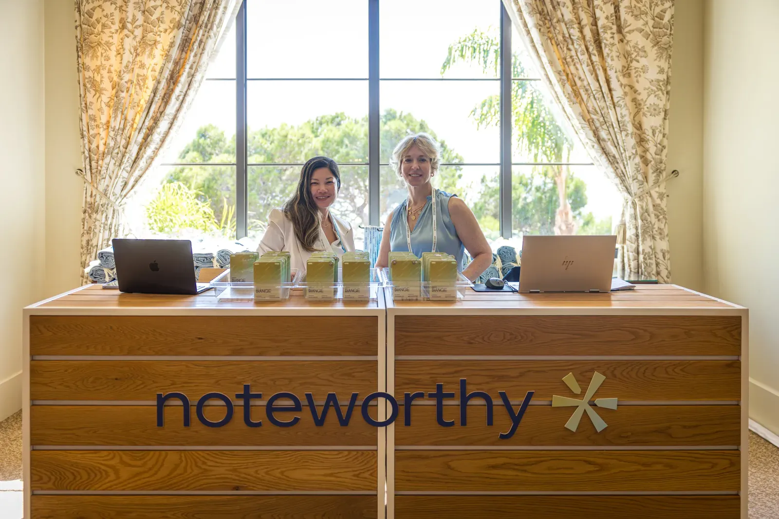 Hosts welcoming guests at the Noteworthy registration desk