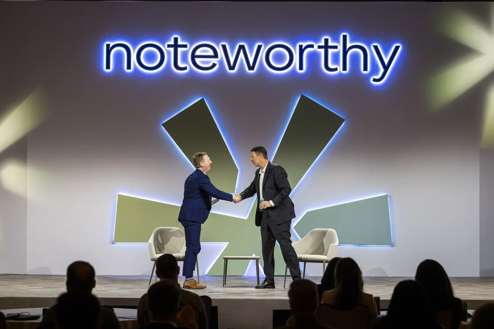 Speakers shaking hands on the Noteworthy main stage