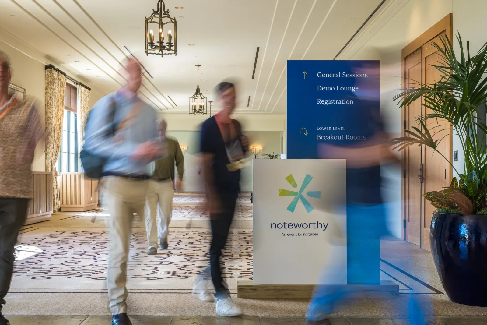 Attendees walking through the Noteworthy venue lobby