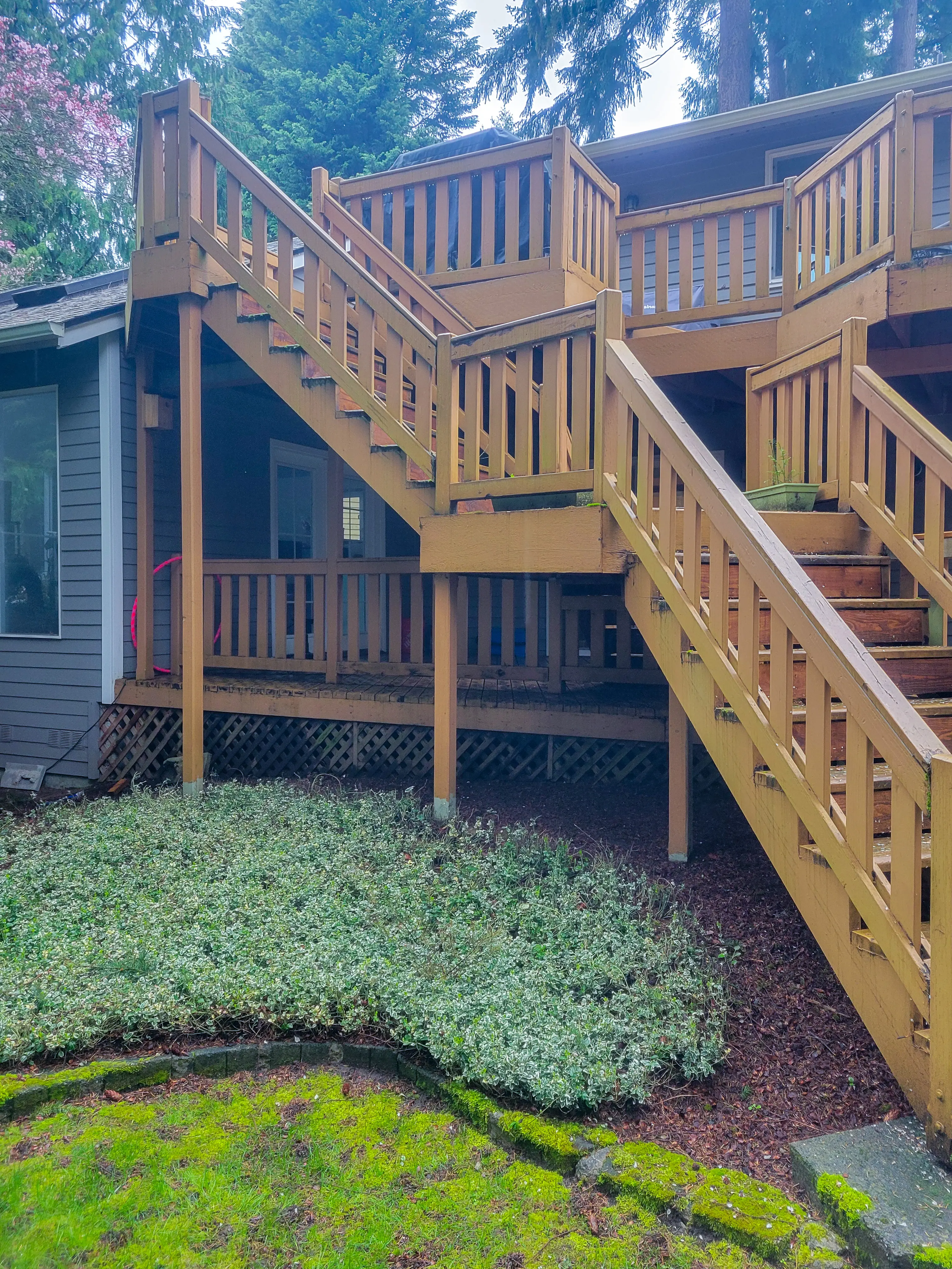 Existing wood deck and staircase on the back of a Kirkland, WA home before an addition project.