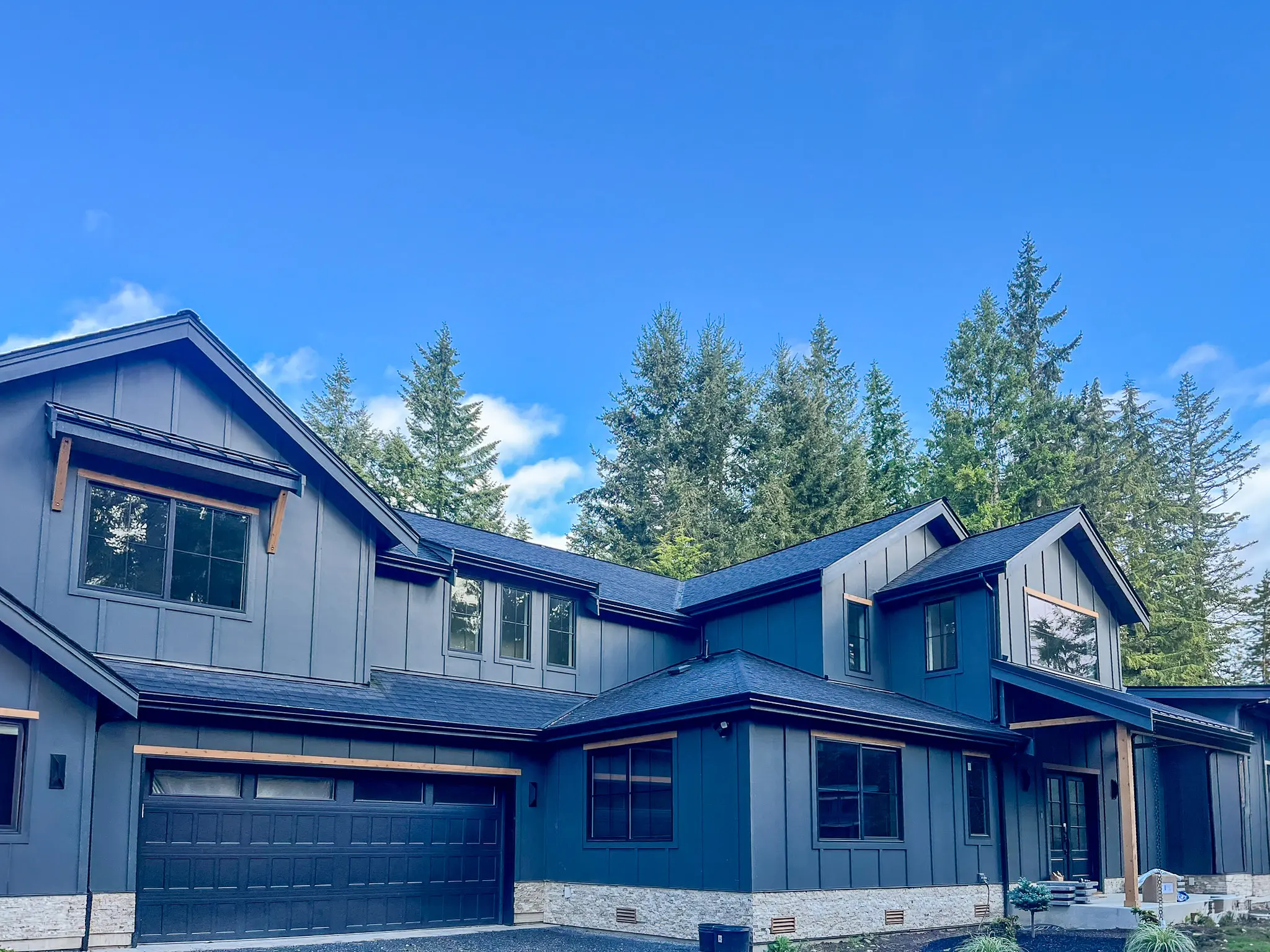 Front exterior of a new custom home in Redmond, WA, showing the garage, covered entry, and upper-story windows.