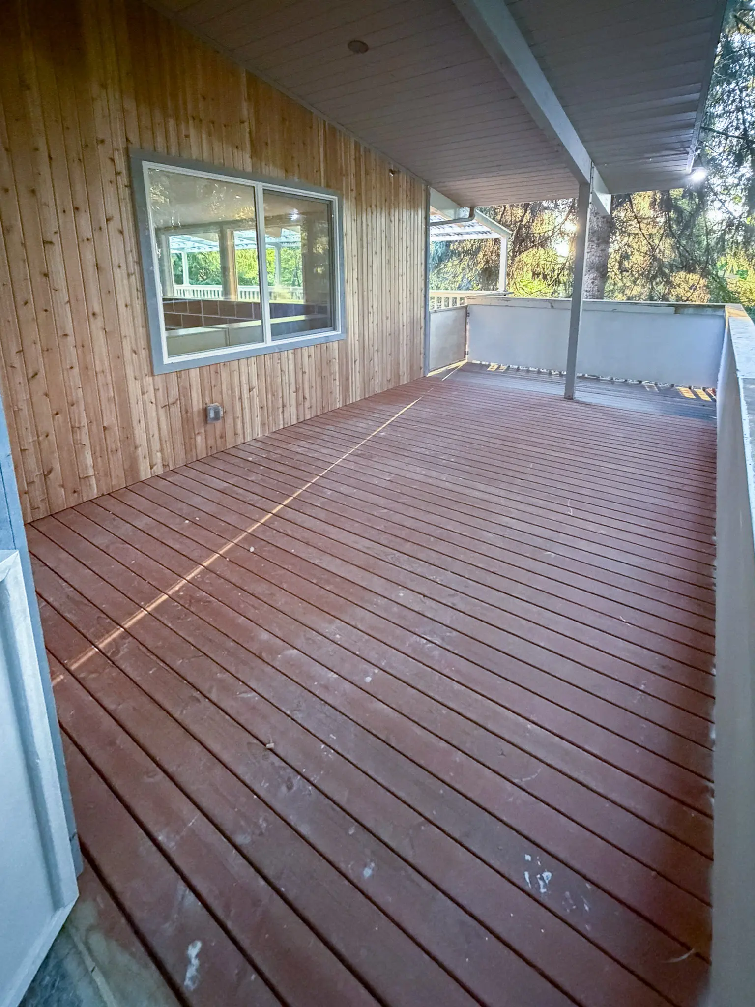 Covered wood deck and walkway attached to a Redmond, WA commercial building before a daycare remodel.