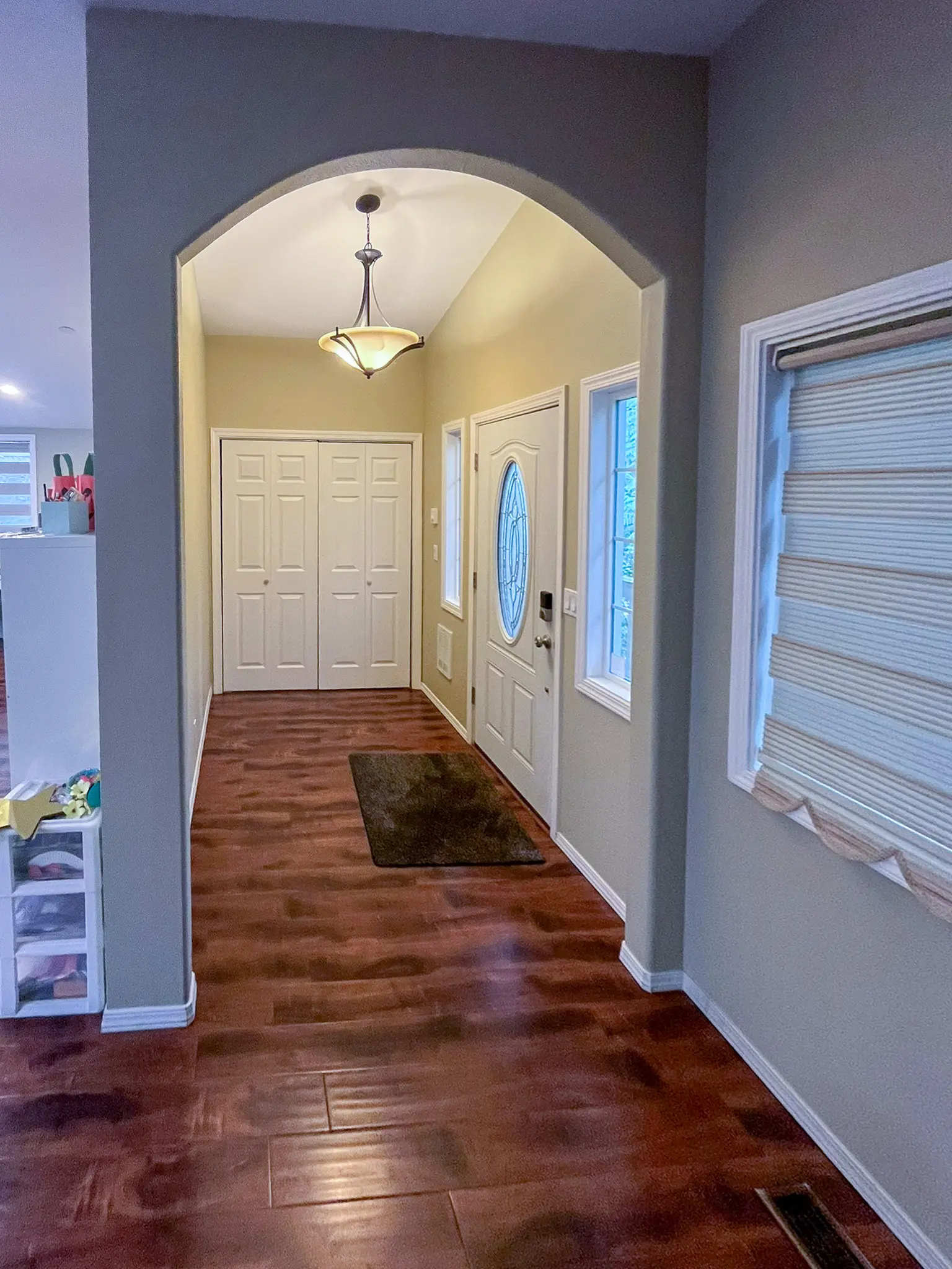 Entry hallway with closet doors and a front door in a Redmond, WA commercial building before a daycare remodel.