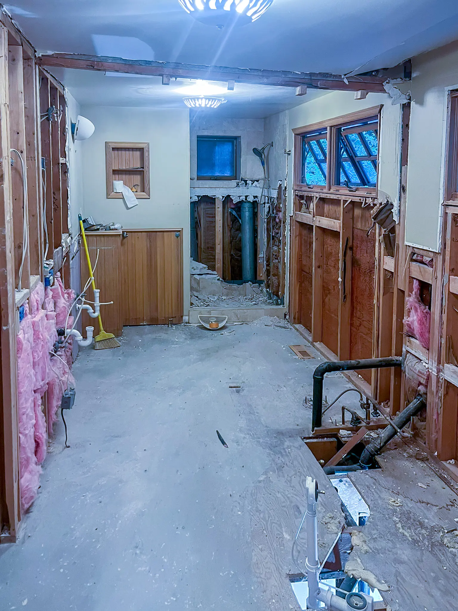 Primary bathroom stripped to studs and subfloor during a Bellevue, WA bathroom remodel.