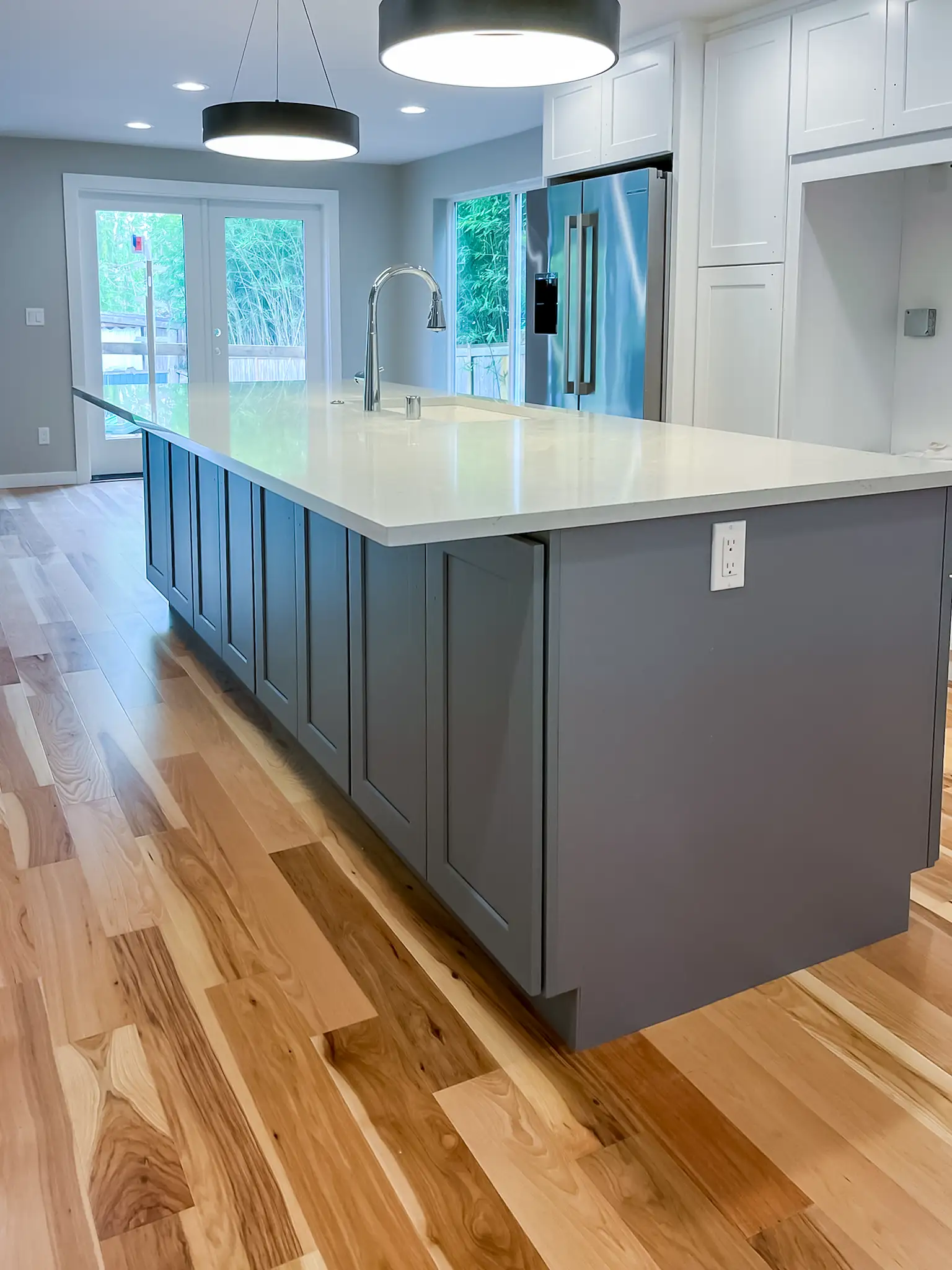 Kitchen island with quartz-look countertop in a remodeled Kirkland, WA rambler.