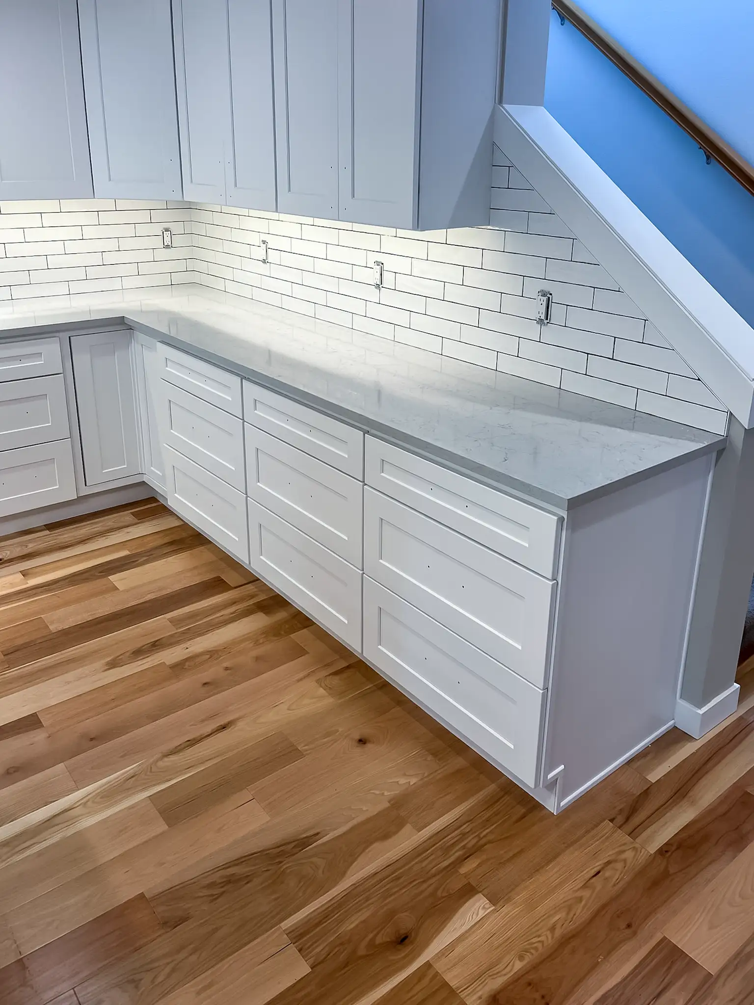 White shaker cabinetry and subway tile backsplash in a remodeled Kirkland, WA kitchen.