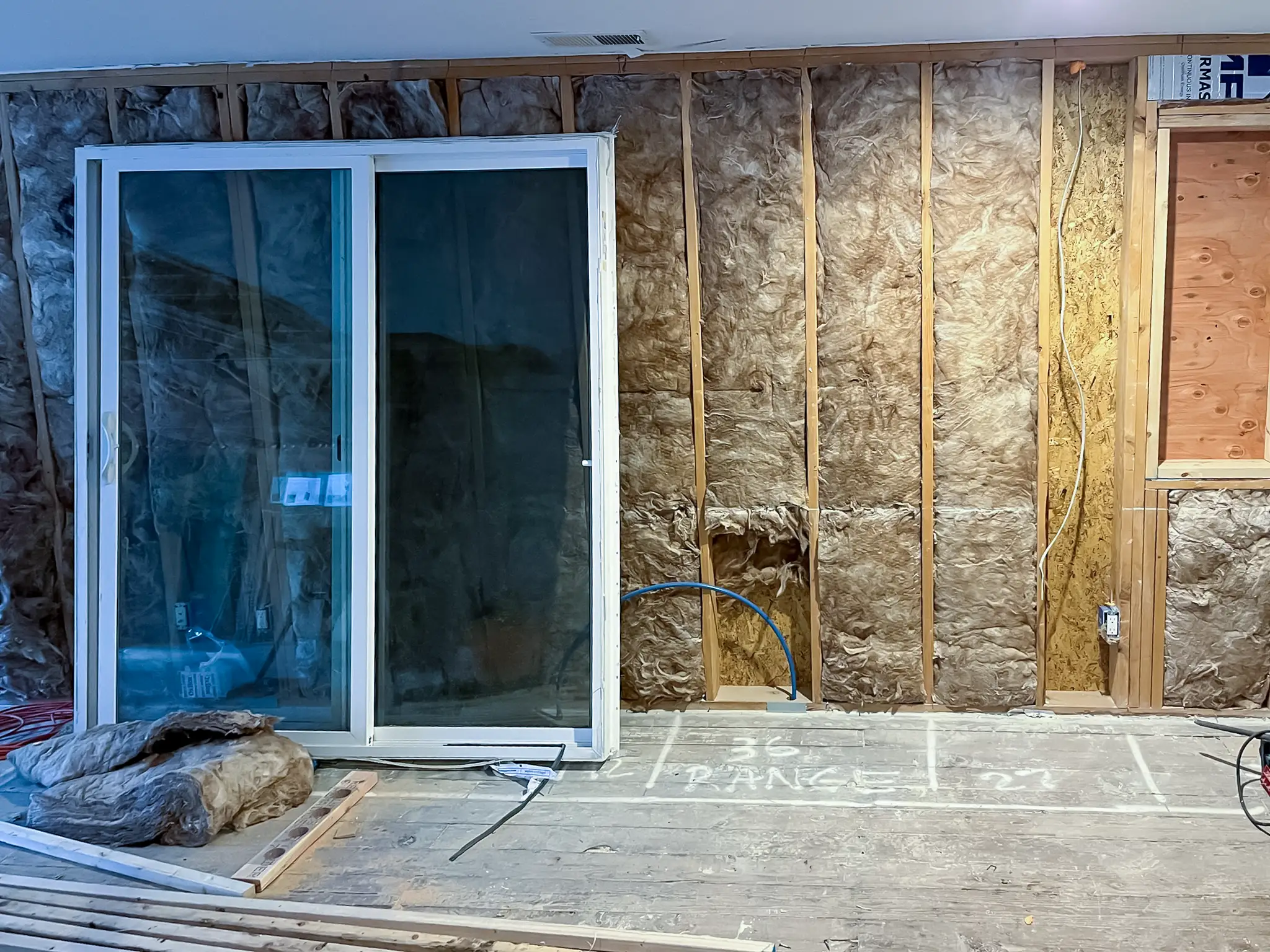 Back door and living room area in a Kirkland, WA rambler before a whole-home remodel.