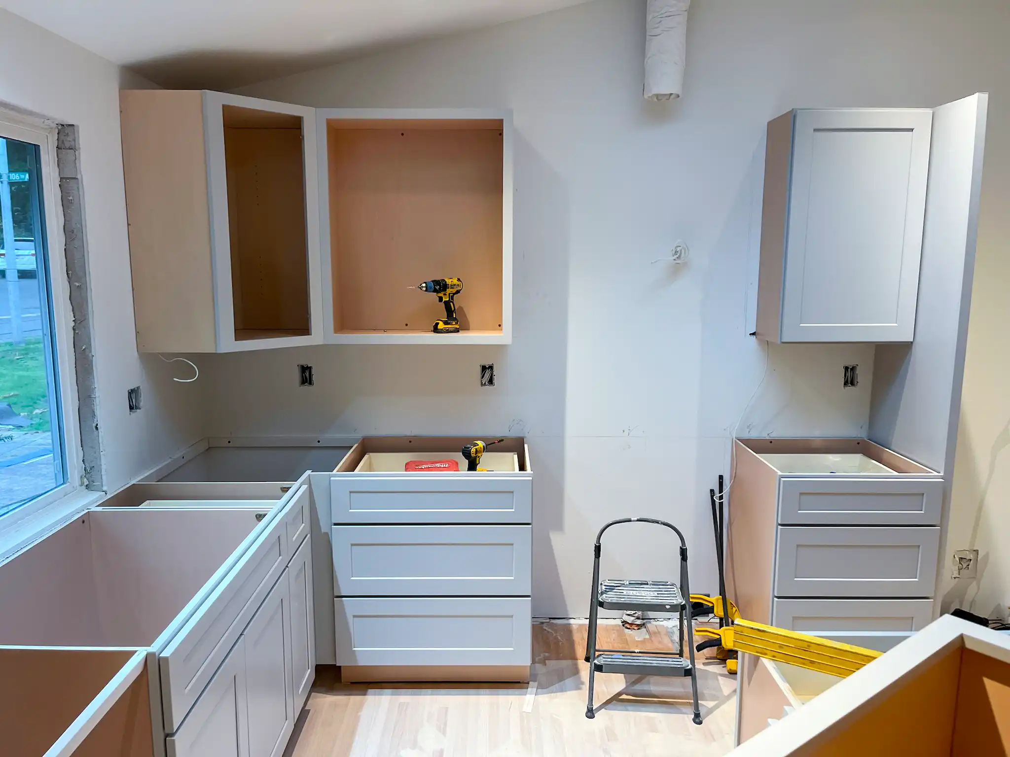 Kitchen midway through construction with new cabinet boxes installed.