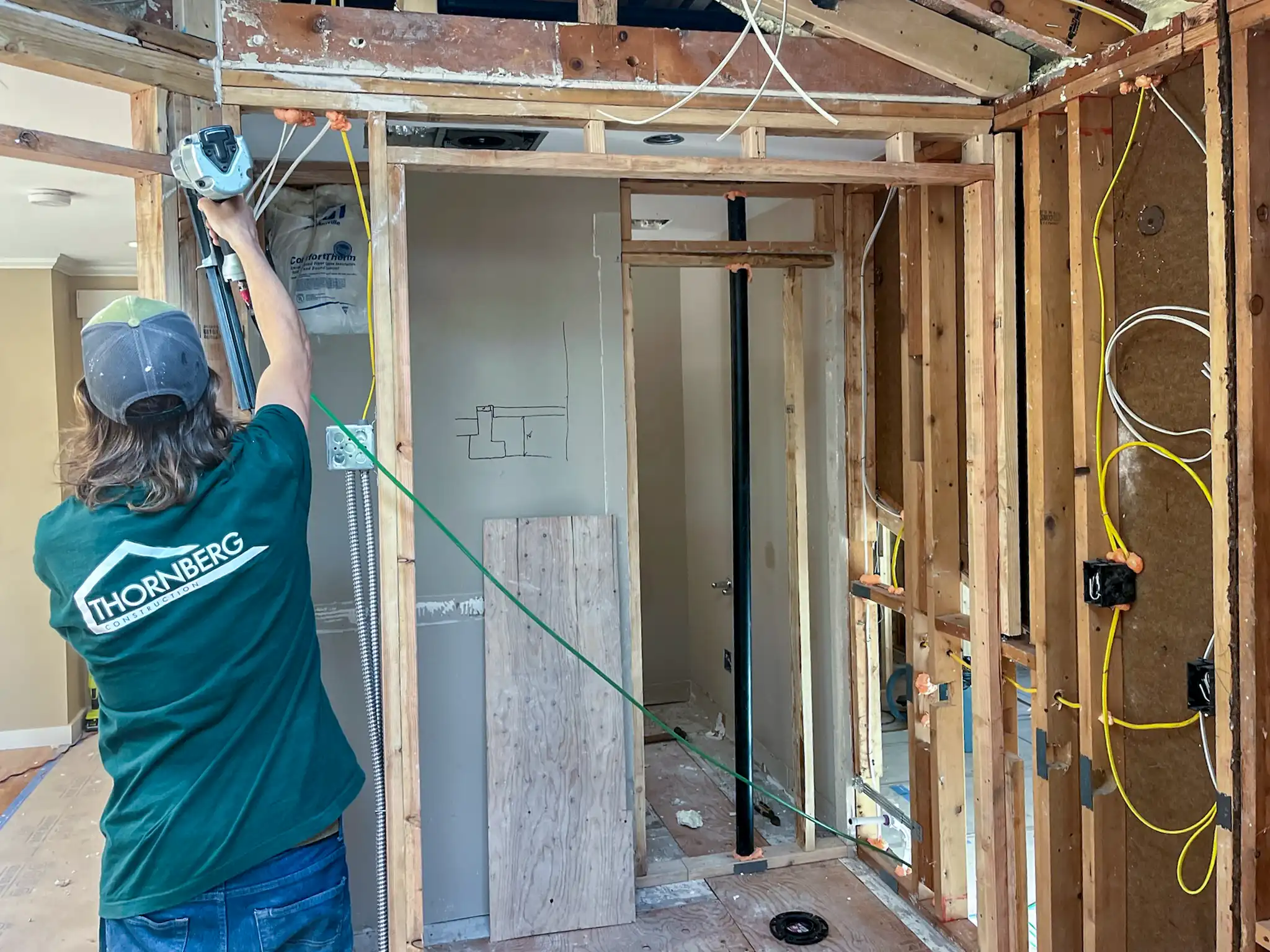 Thornberg Construction crew member working in the stripped-down interior during the remodel.