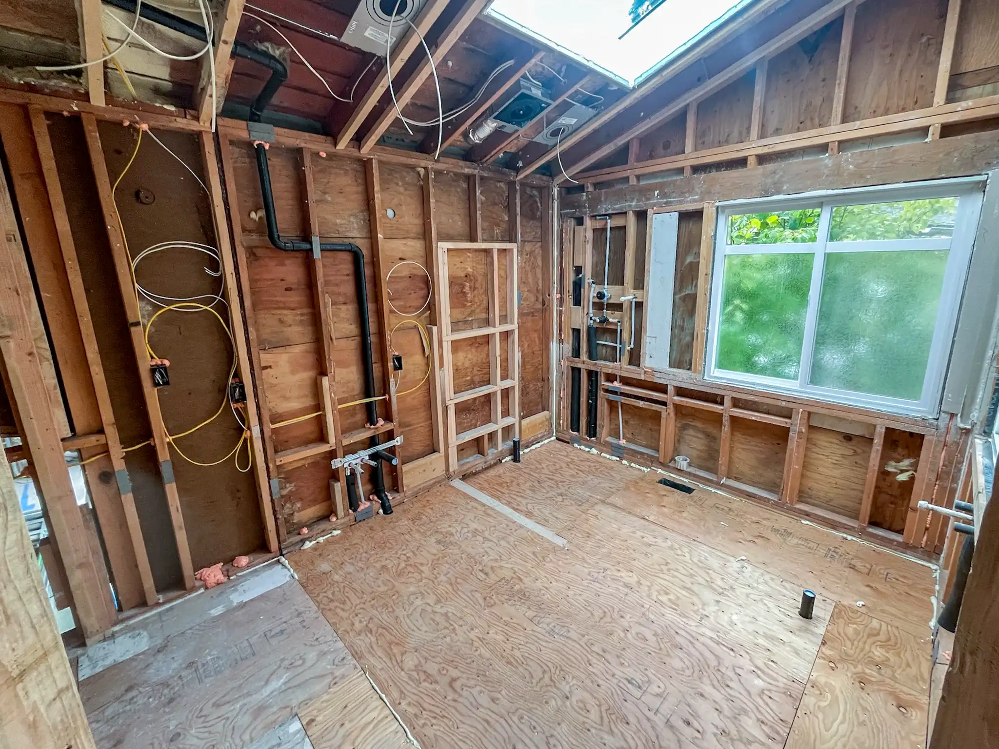 Downstairs interior with exposed framing before a Kirkland, WA kitchen and bathroom remodel.