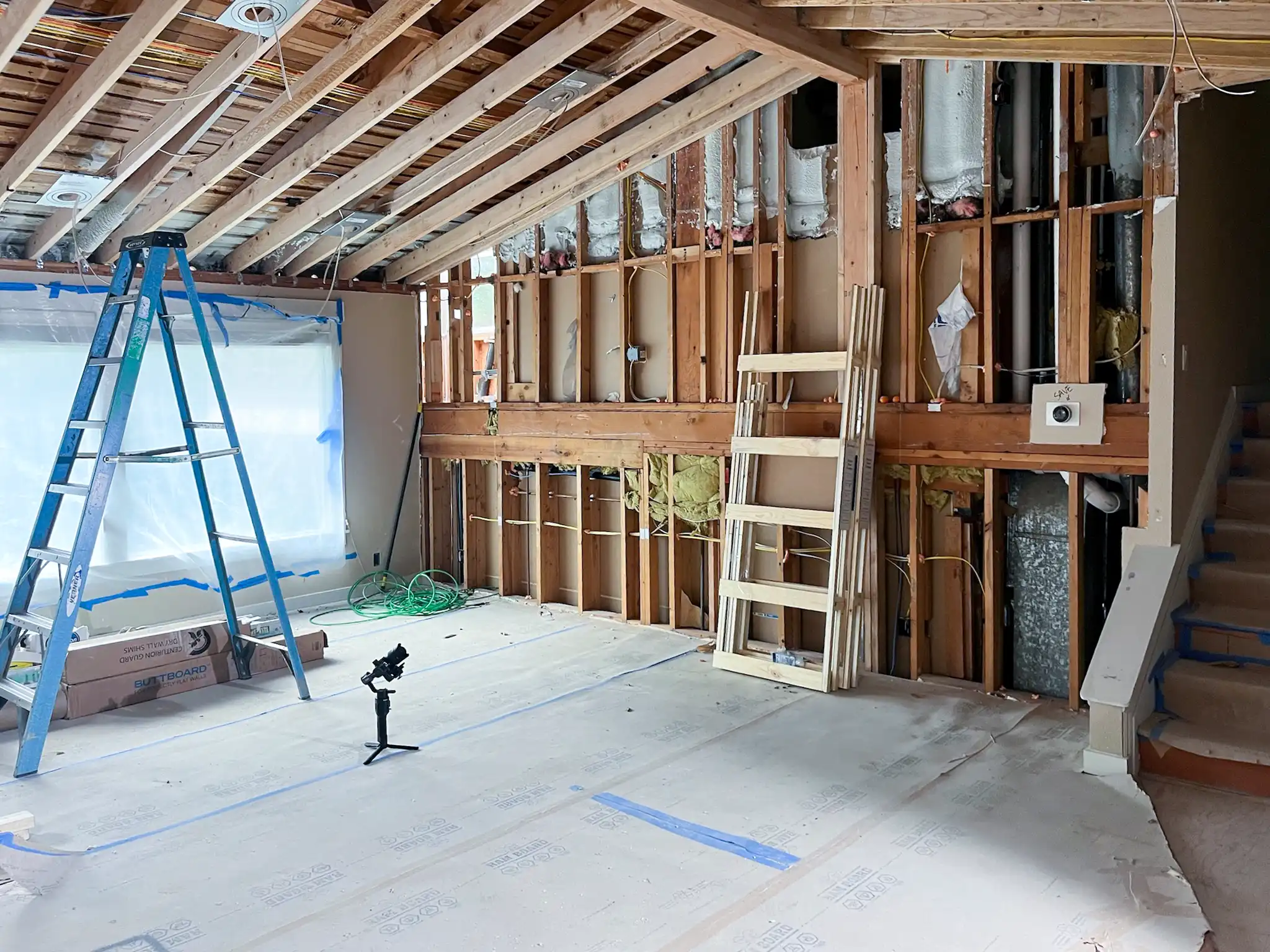 Kitchen area stripped to the studs and subfloor before a Kirkland, WA kitchen and bathroom remodel.
