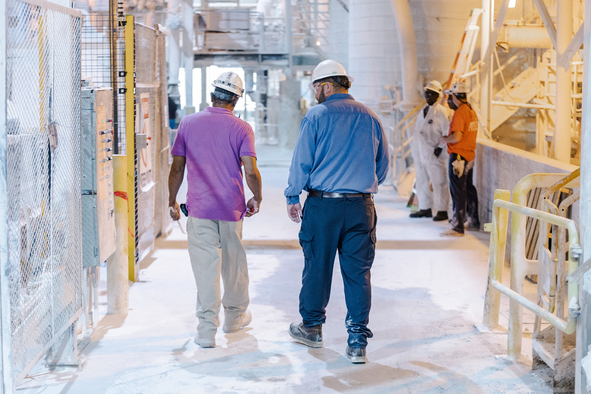 kamin employees in hard hats walking through mcintyre georgia manufacturing plant