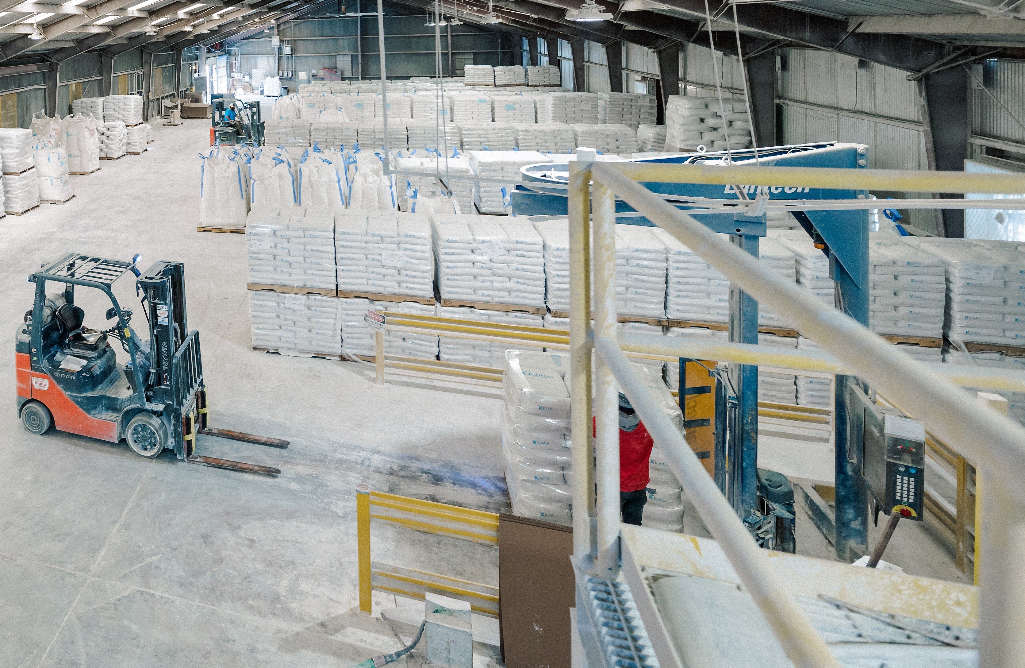 warehouse with kaolin clay bags and bulk shipping