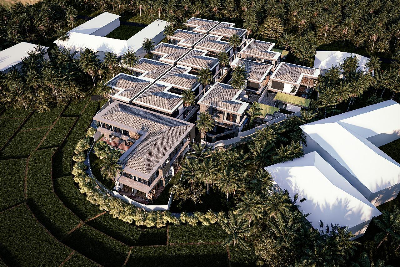 Aerial view of a modern villa complex with multiple L-shaped buildings surrounded by palm trees and greenery.