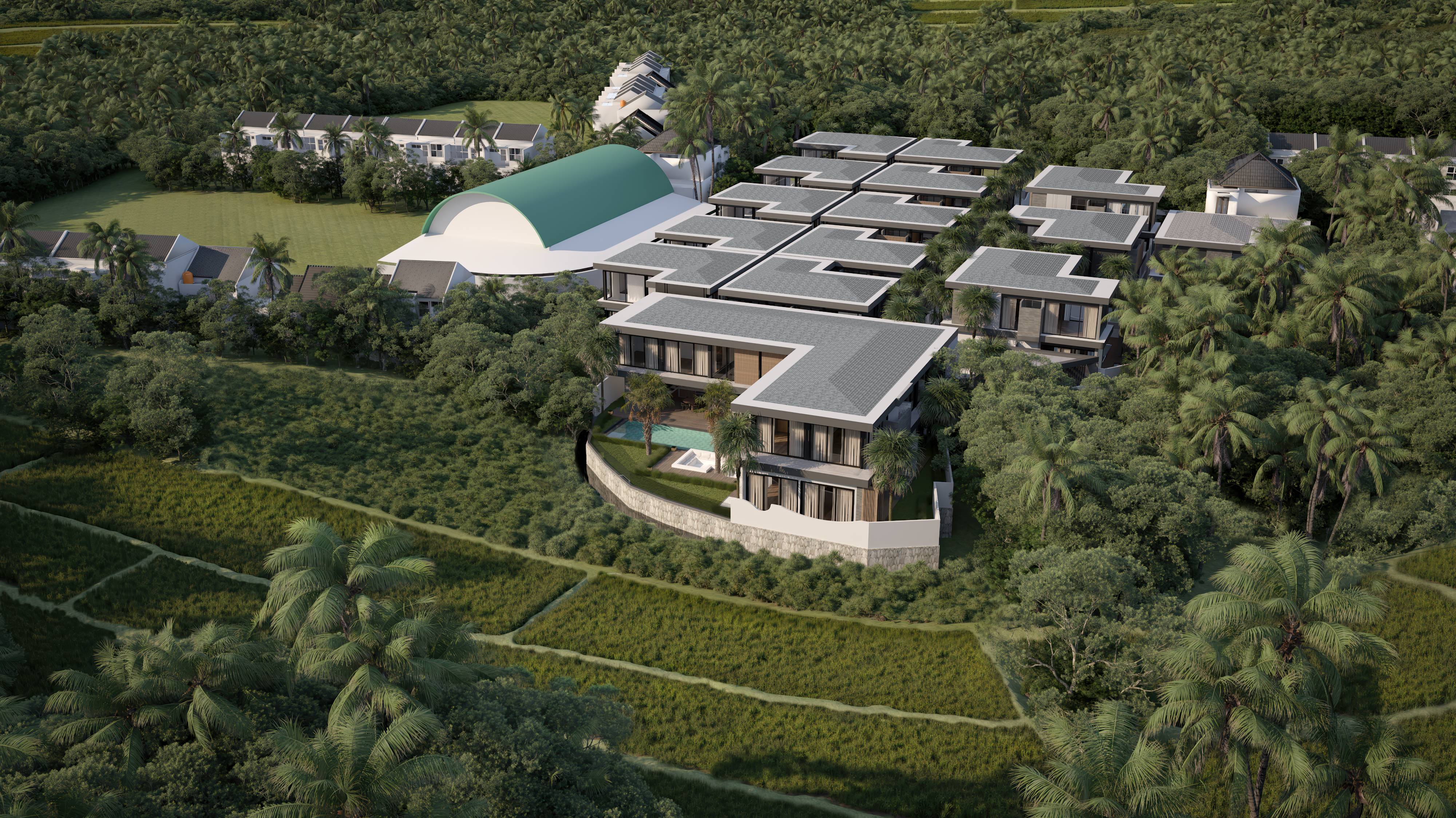 Aerial view of a modern residential complex surrounded by tropical trees and greenery, featuring multiple grey-roofed buildings and a curved green-roof structure.