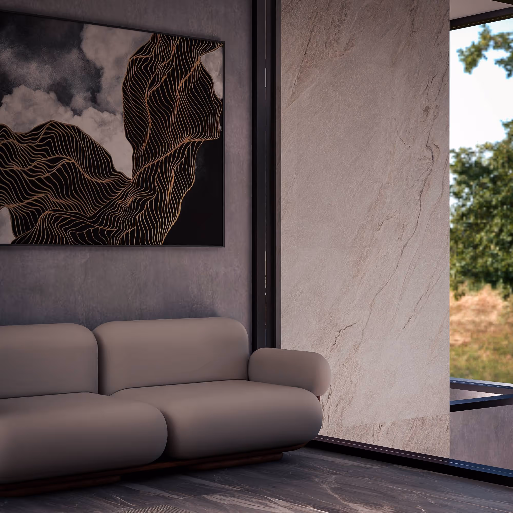 Modern living room with a curved gray sofa, abstract black and gold wall art, and large window showing greenery outside.