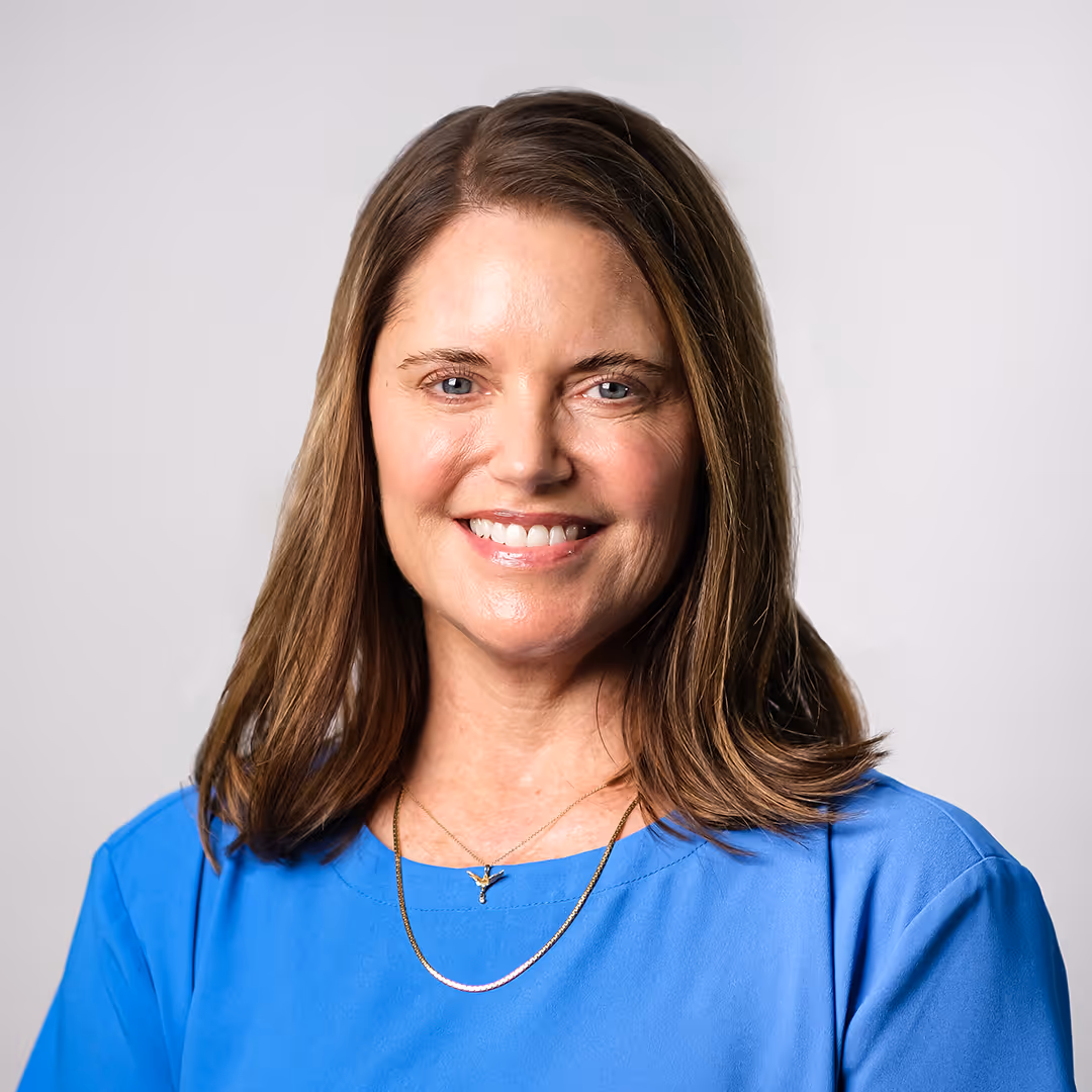 Professional headshot of a mental health clinician in a blue shirt. photographed by Helm Business & Marketing Solutions to help therapy practices build trust and attract ideal clients.