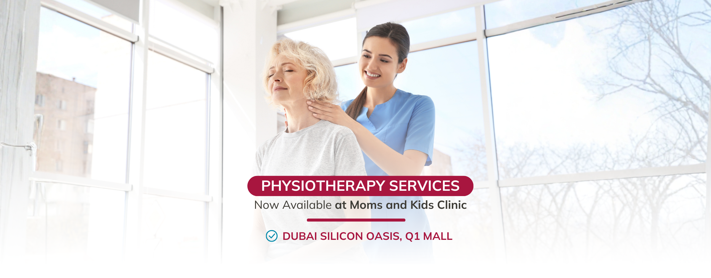 A physiotherapist in blue scrubs massaging the neck of a relaxed elderly woman in Fakeeh Medicenters