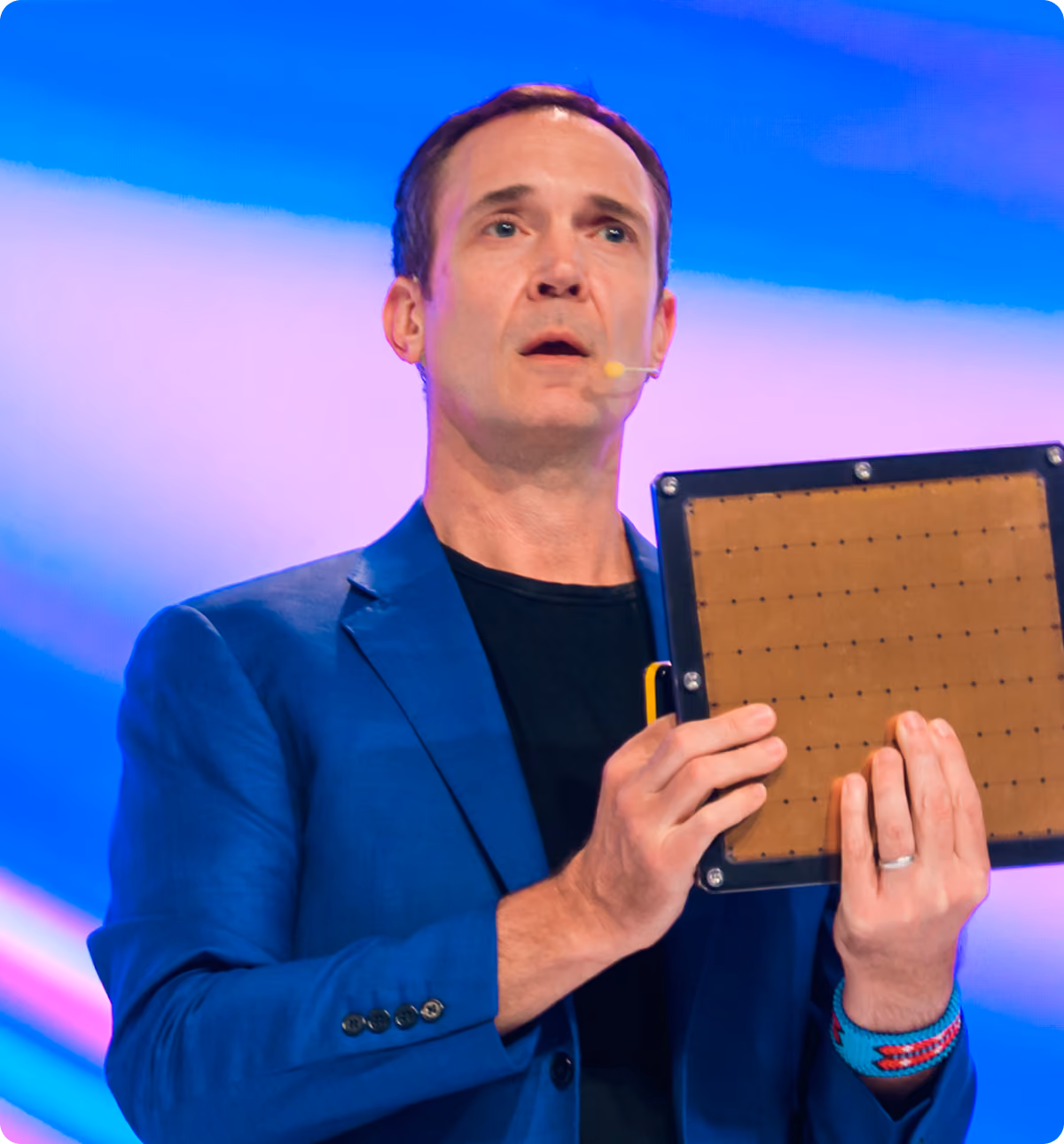 Andy Hock, Cerebras Systems CSO and SVP, holding a wafer-scale chip while speaking at SuperAI 2026.