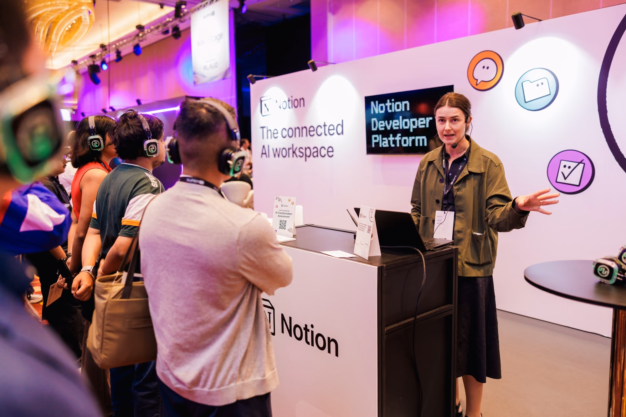 	Notion representative presenting the Notion Developer Platform to attendees at the SuperAI 2026 booth.