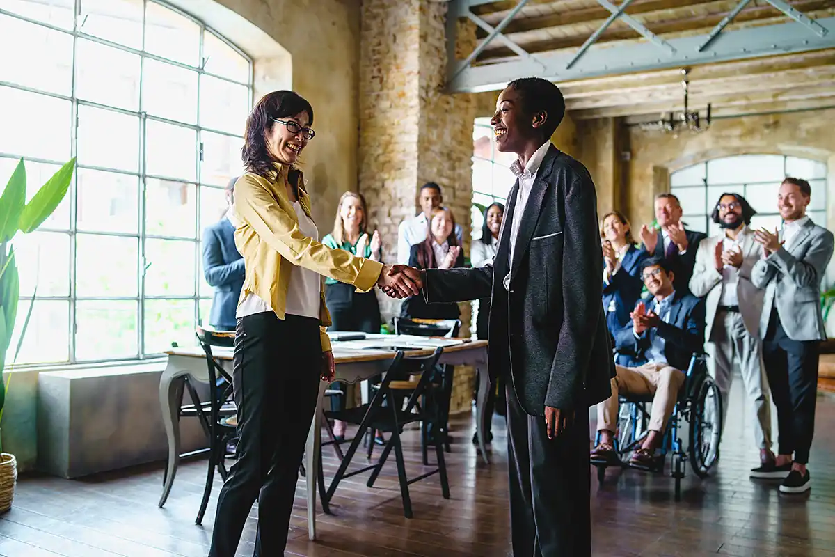 Man and woman shaking hands in entryway