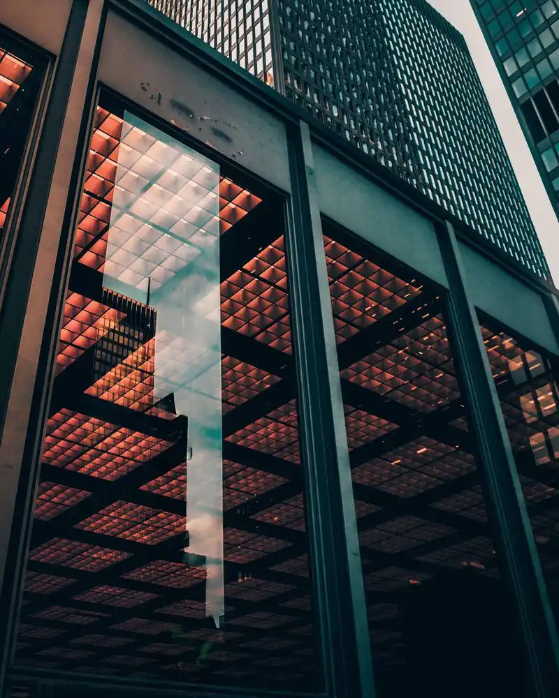 Bottom of building skyscraper showing glass and lighting
