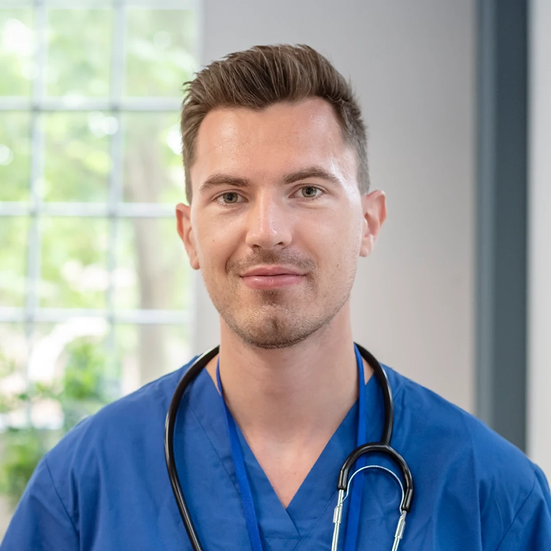 nurse smiliog in front of camera