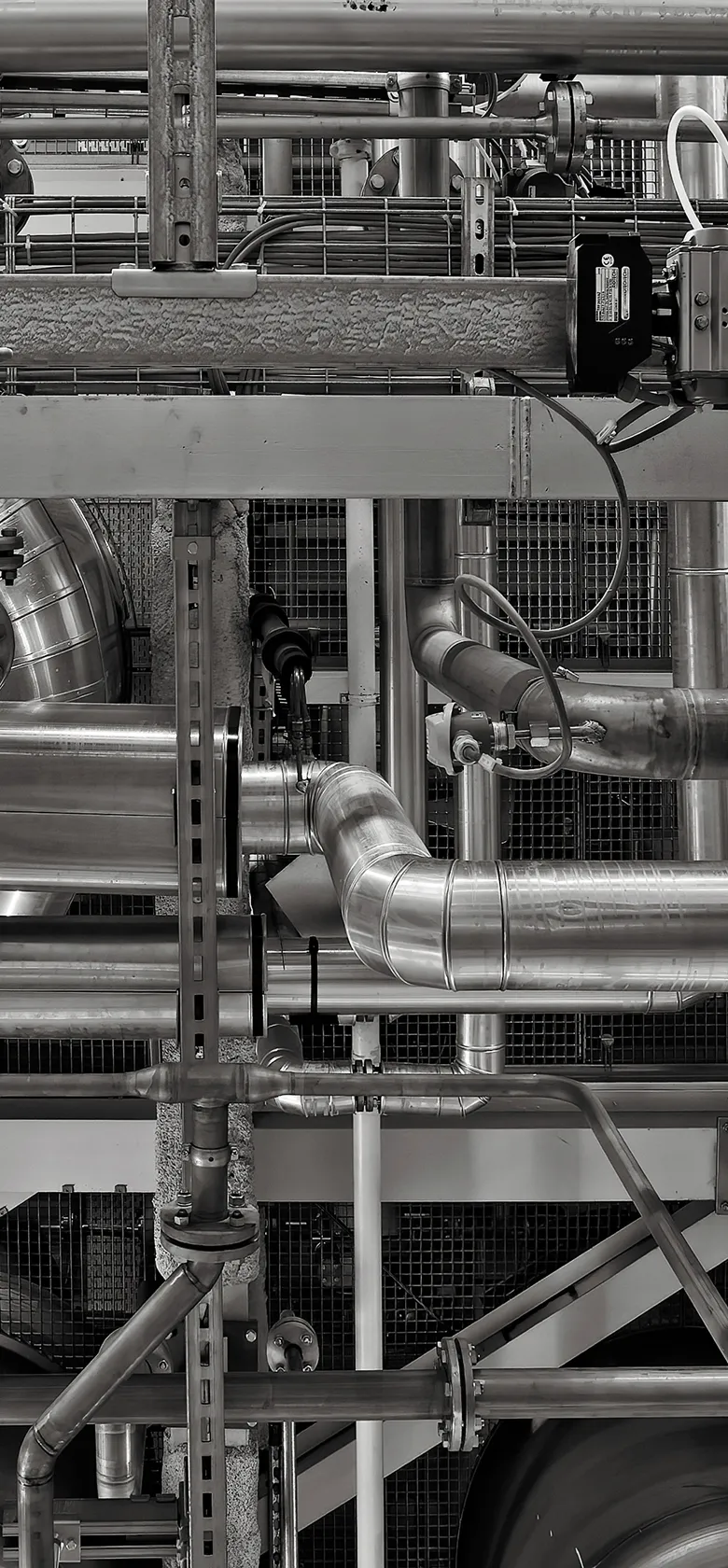 Industrial MEP pipes, valves, and machinery in a factory setting showcasing complex engineering and precision.