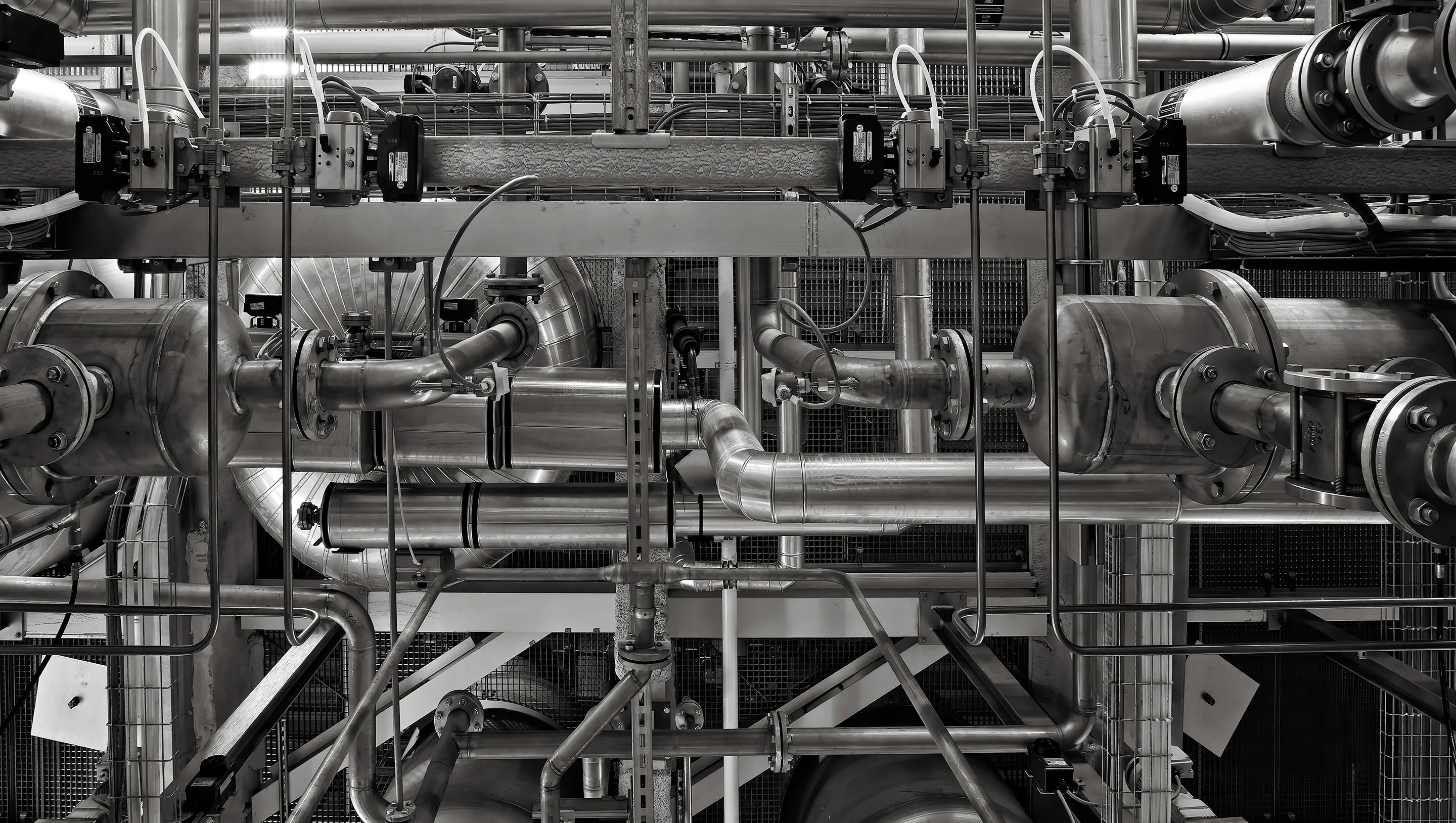 Industrial MEP pipes, valves, and machinery in a factory setting showcasing complex engineering and precision.