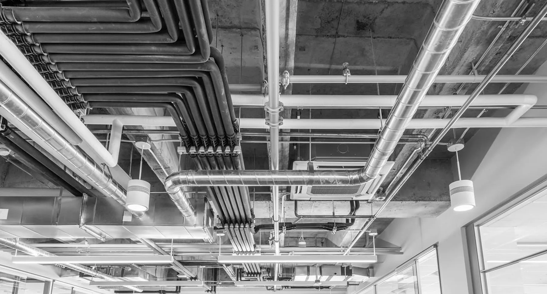 Organized MEP systems with ceiling pipes and cables designed for efficient infrastructure and building operations.