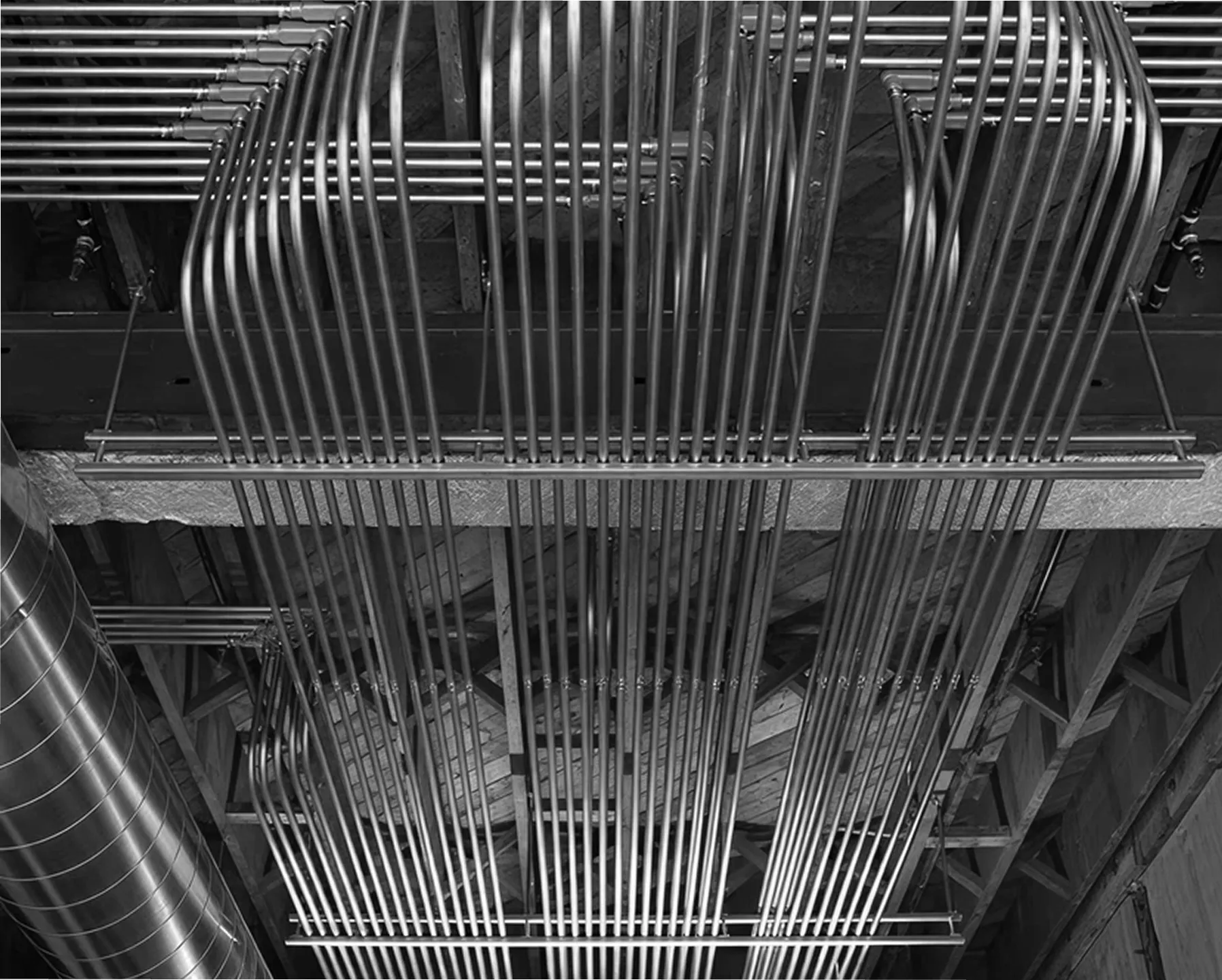 Industrial MEP systems with aligned metal pipes, showcasing precise engineering for efficient infrastructure design.