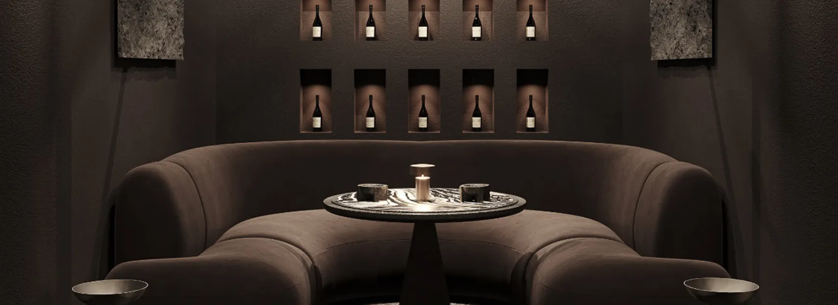 Modern lounge area with curved sofa and MEP-integrated lighting showcasing wine bottle displays for ambiance.
