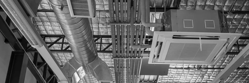 MEP systems with HVAC ductwork, insulated piping, and a ceiling-mounted air conditioning unit.